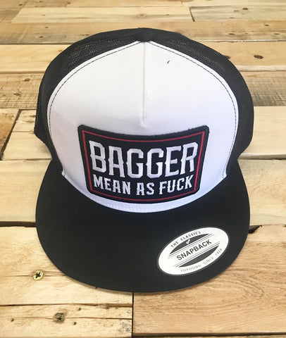 Black and white cap with 'Bagger Mean as Fuck' text on a wooden surface