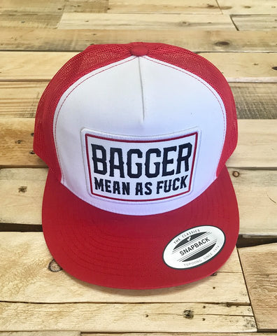 Red and white cap with text on a wooden surface