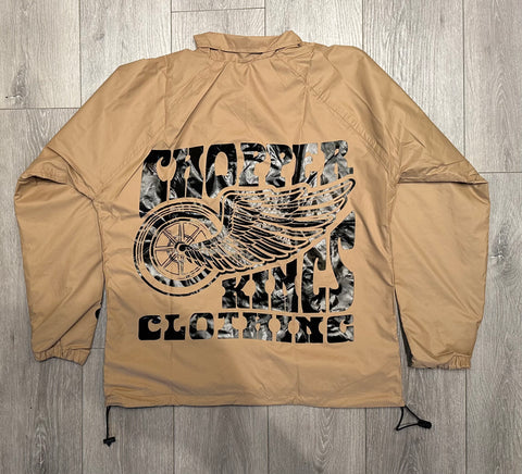 Beige jacket with graphic design on a wooden floor