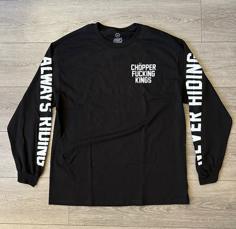 Black long-sleeve shirt with white text on a wooden surface