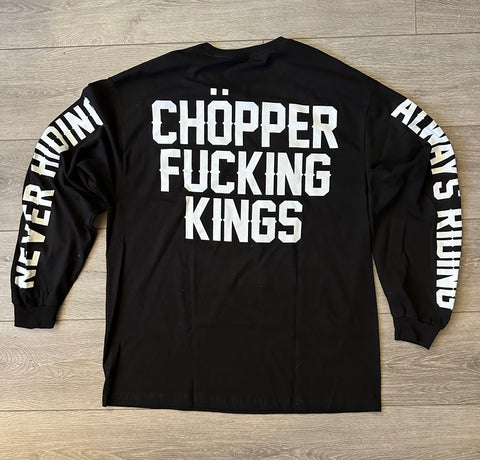 Black long-sleeve shirt with white text on a wooden surface