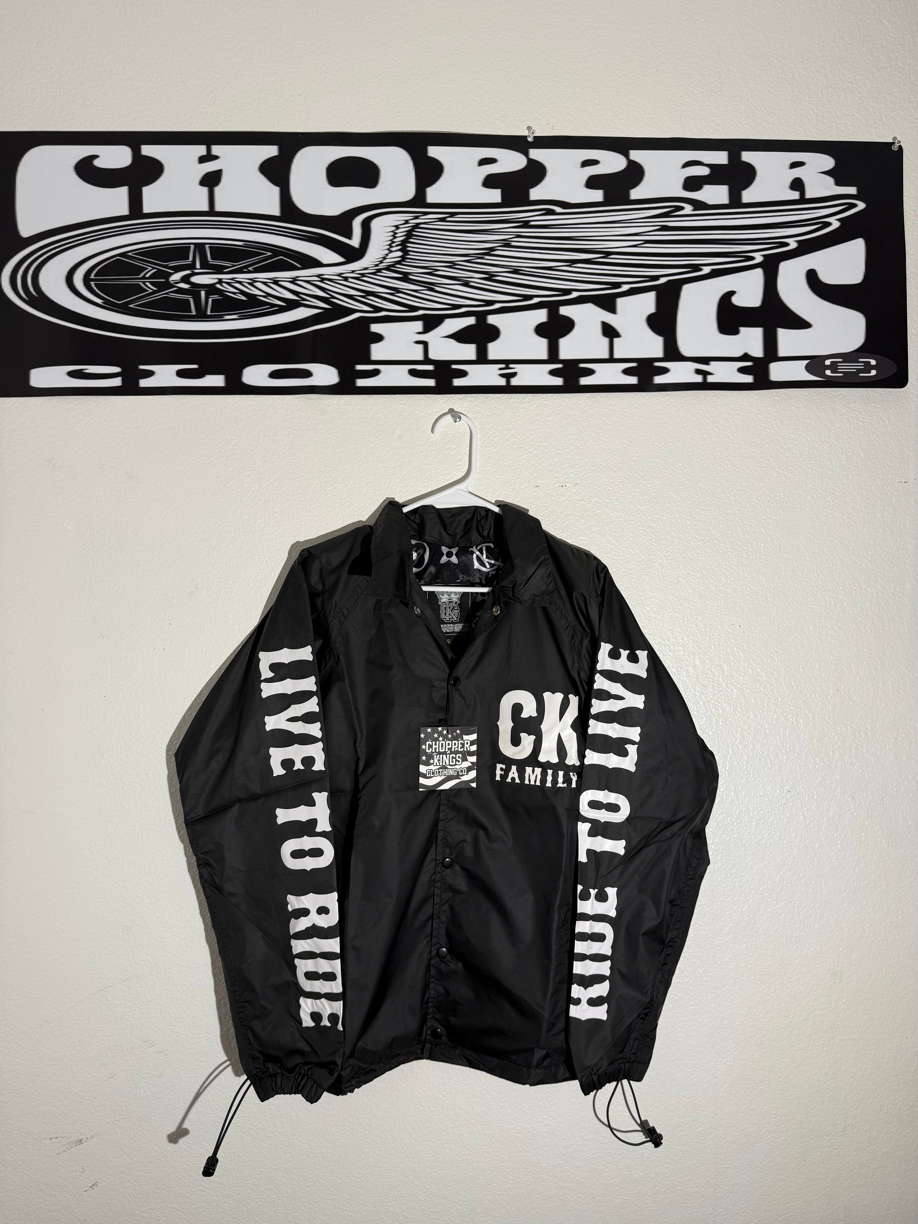 Black jacket with 'Live to Ride' text and a banner with motorcycle graphic on a white background