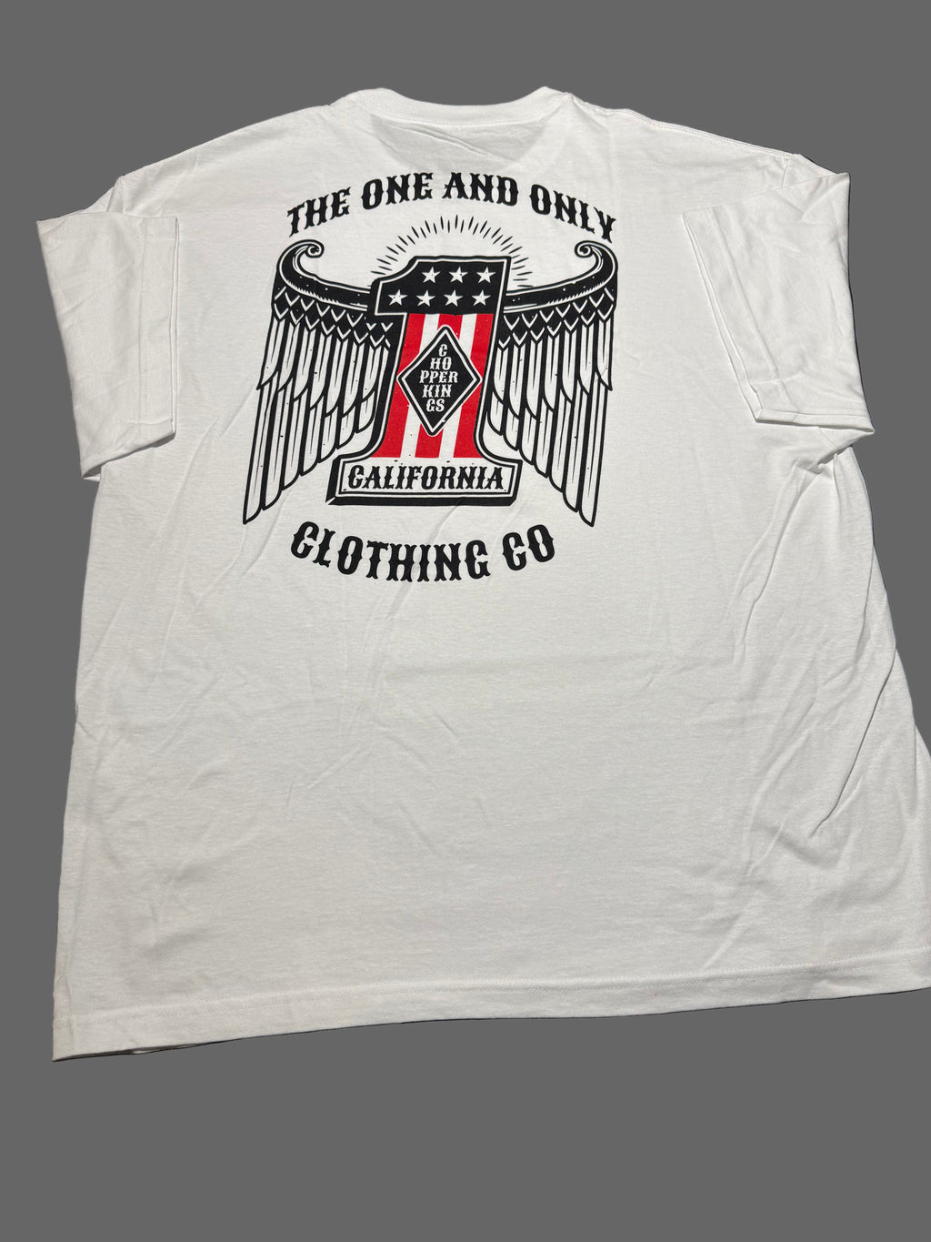 White t-shirt with a graphic design on a dark background