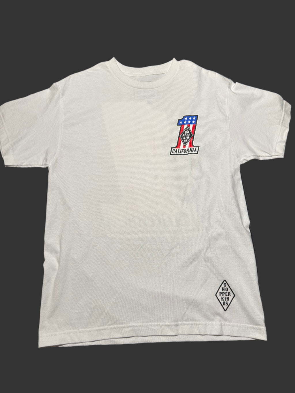 White sleeveless shirt with a logo on a dark surface