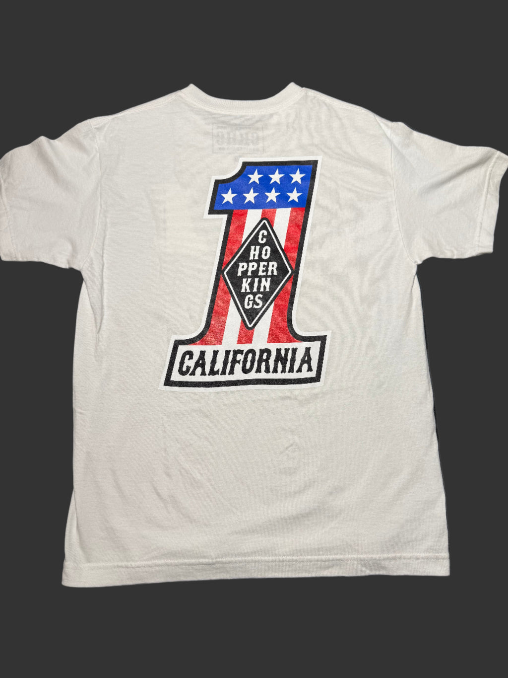 White tank top with a graphic design on a dark surface