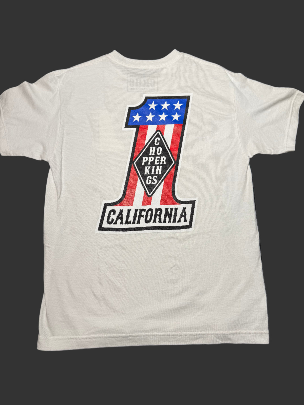White tank top with a graphic design on a dark surface