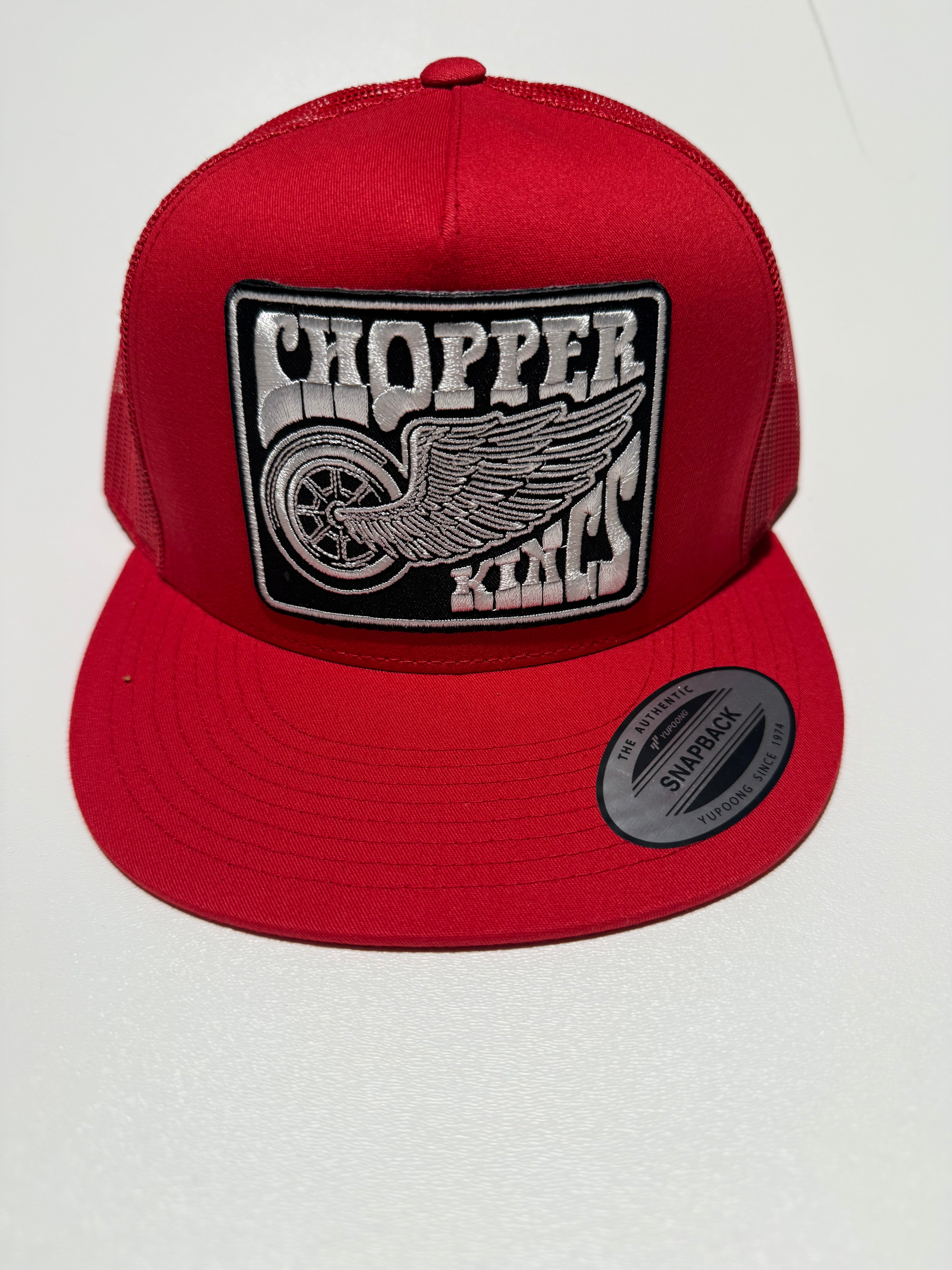 Red cap with a black and white logo on a white background