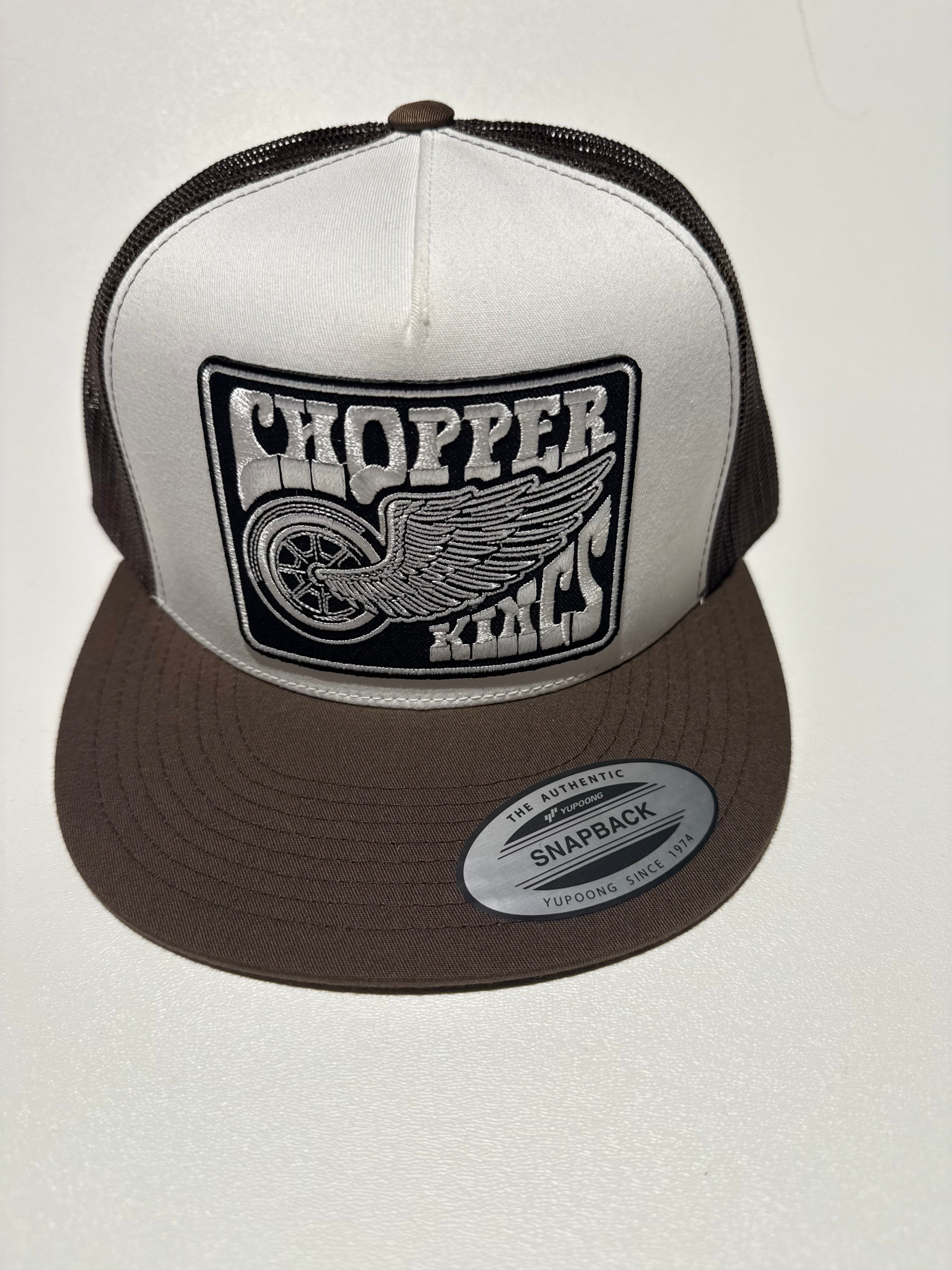 Brown and white cap with a logo on a light gray background