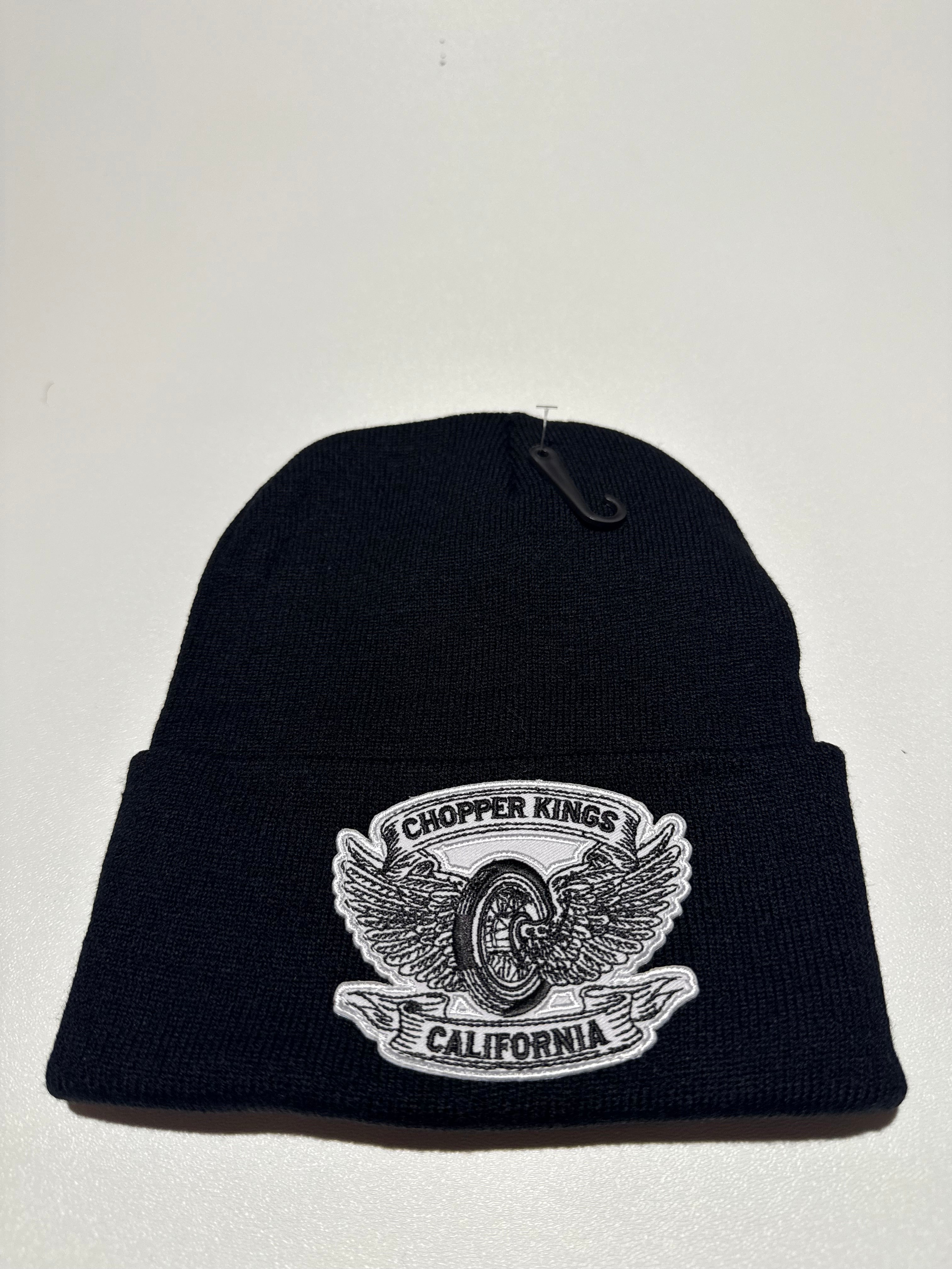 Black beanie with a logo on a light gray background