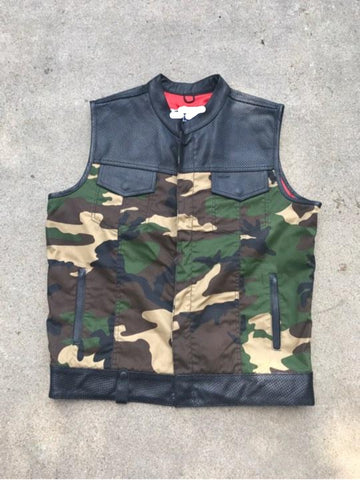 Camouflage vest with black leather accents on a concrete floor