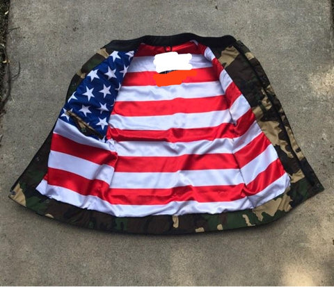 Jacket with American flag inside with camouflage border on a concrete surface