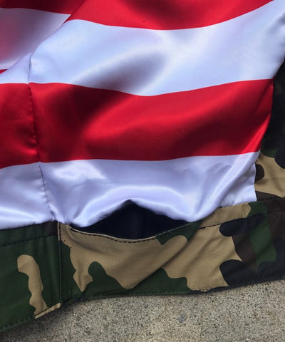 Close-up of a jacket with camouflage pattern and American flag design.