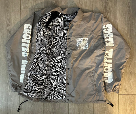 Gray jacket with black and white text design on a wooden floor