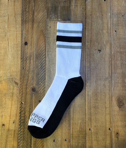 White sock with black accents on a wooden surface