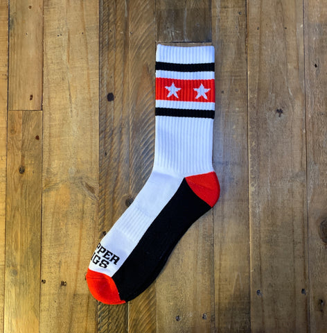 White sock with red and black accents on a wooden surface
