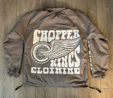Brown jacket with 'Chopper King Clothing' logo on a wooden floor